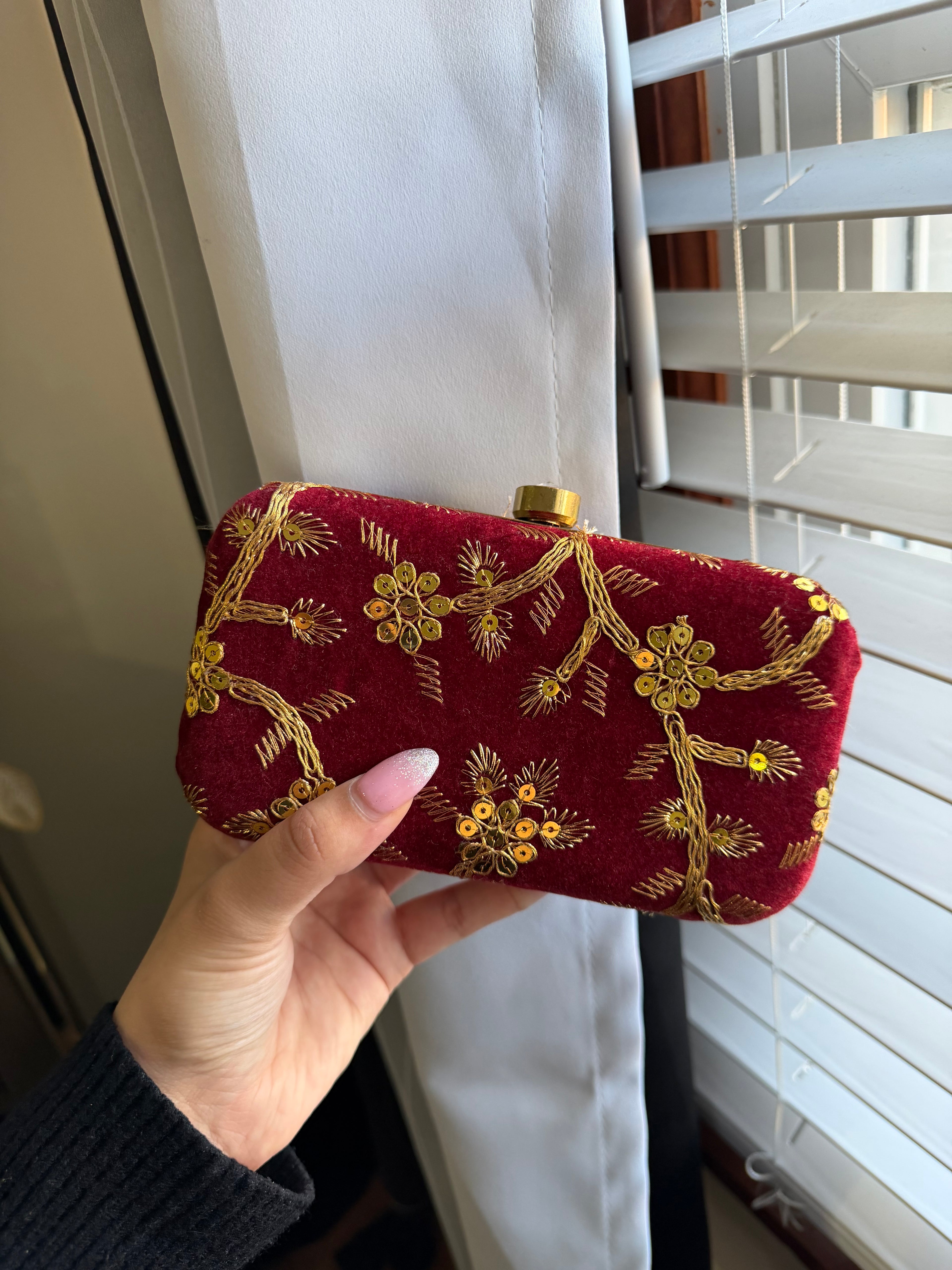 Maroon clutch with golden embroidery