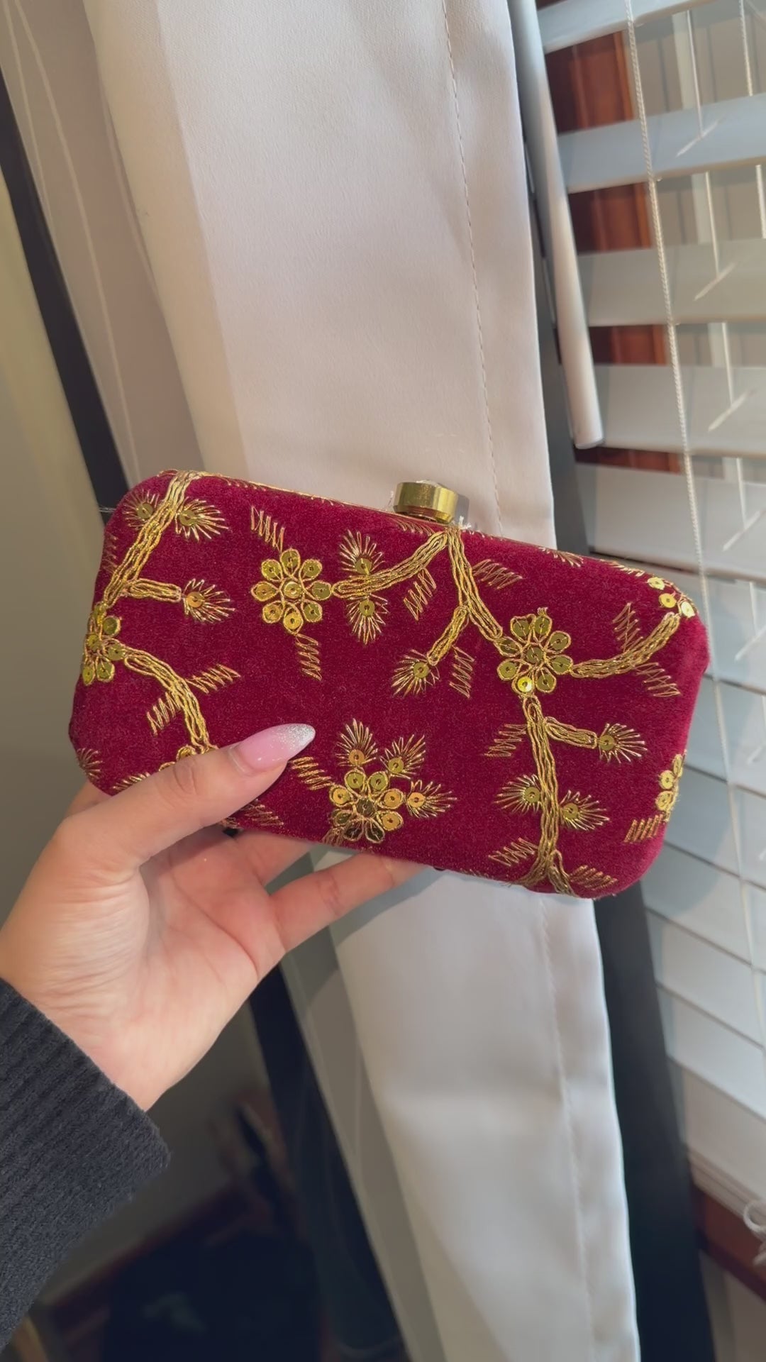 Maroon clutch with golden embroidery